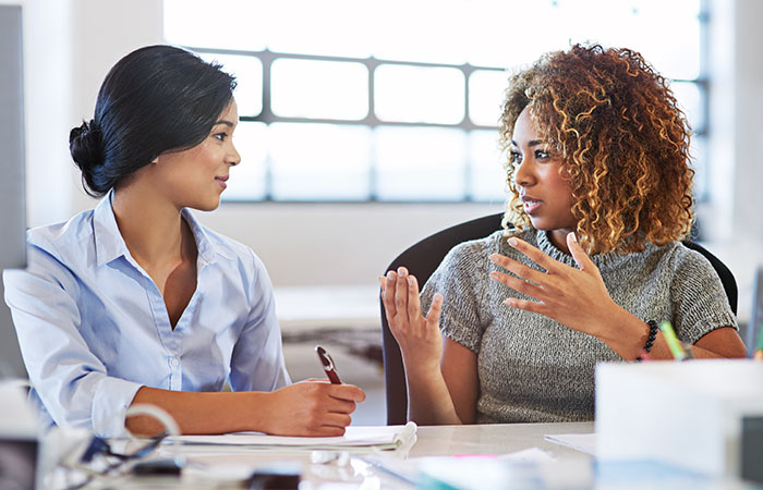 Two women discussing a project